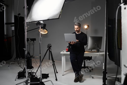 Preview: Creative professional at work in a modern studio setting focused on digital editing tasks