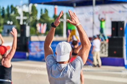 Preview: Young woman warming up before running marathon