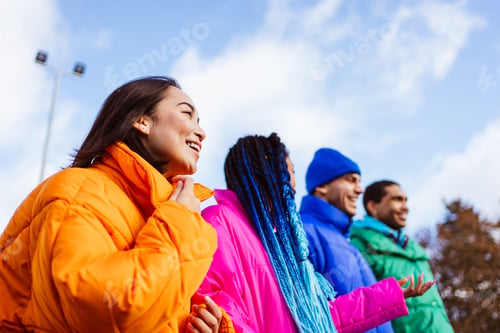 Preview: Multiracial group of young friends meeting outdoors in winter