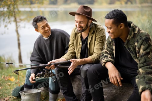 Preview: Multiracial male friends rest and talk in nature