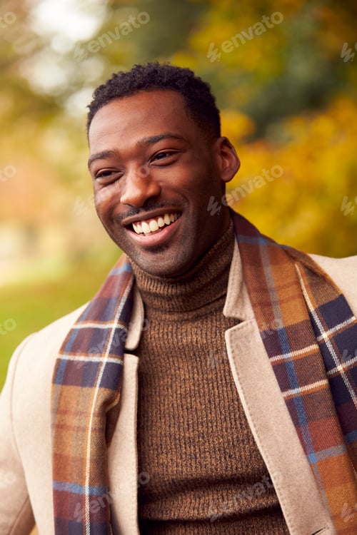 Preview: Head And Shoulders Portrait Of Man On Walk Through Autumn Countryside Against Golden Leaves