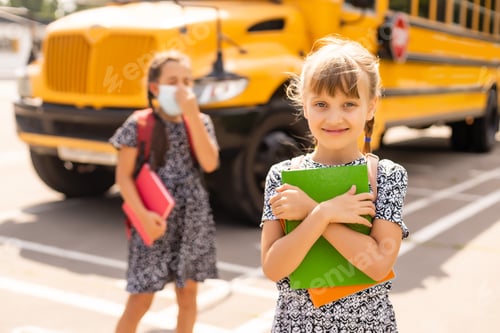 Preview: Portrait of a girl in a surgical mask. Concept of coronavirus COVID-19. Schoolgirl wearing medical