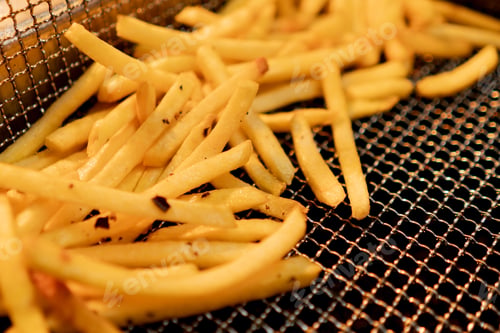 Preview: kitchen in the hotel restaurant, delicious freshly prepared French fries lie in the fryer close-up