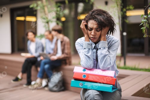 Preview: Portrait of upset lady sitting on bench with colorful folders on knees and sadly closing her eyes