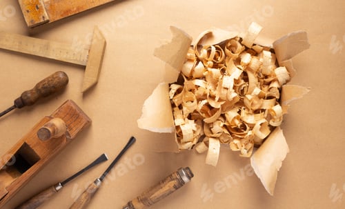 Preview: Woodworking carpenter chisel tool and wood shavings at paper background