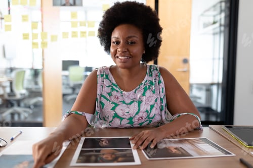 Preview: Happy african american businesswoman sitting at desk having video call conversation in meeting room