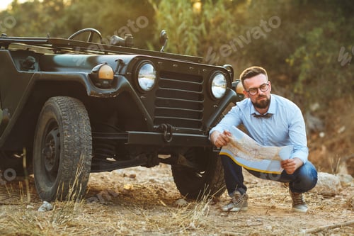 Preview: Young stylish man with glasses and bow tie see the map near the