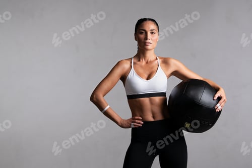 Preview: Athletic Woman Holding a Black Medicine Ball