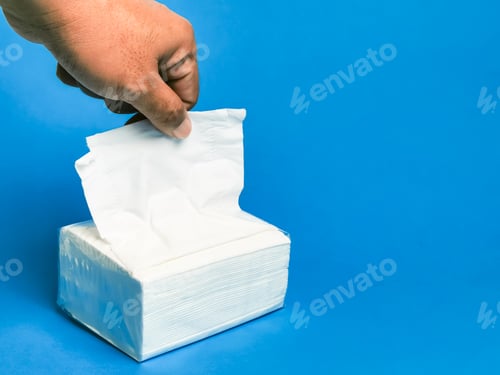 Preview: Photo a pack of white paper napkins against blue background.