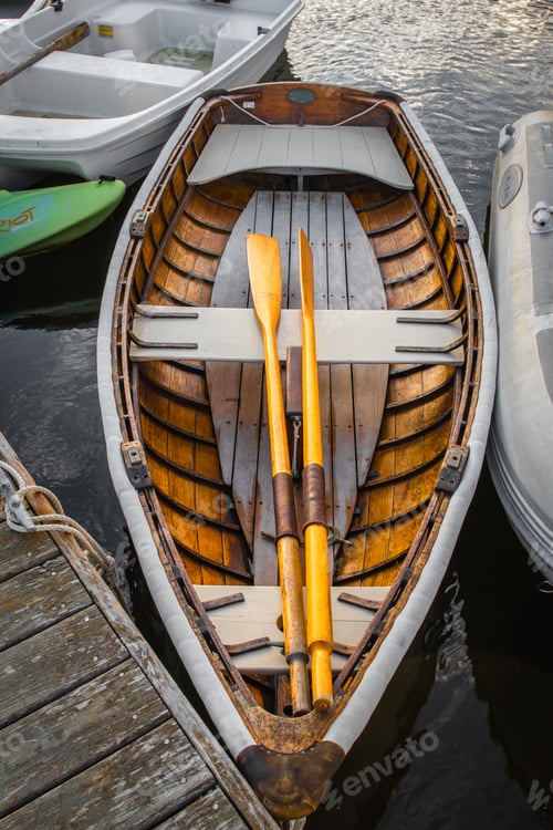 Preview: Vertical closeup of a wooden rowboat in harbor in New England