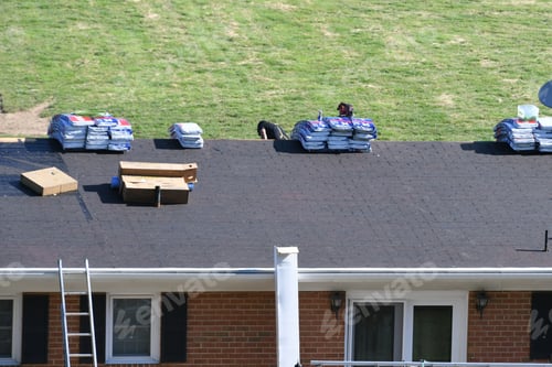 Preview: Roofers roofing company repairing a damaged roof with holes, insurance claim storm damage