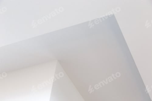 Preview: Bottom view of a wall corner and white plasterboard ceiling.