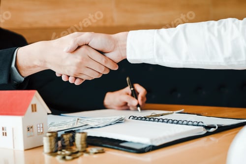 Preview: Home sales agents and buyers work on signing new homes and shaking hands.