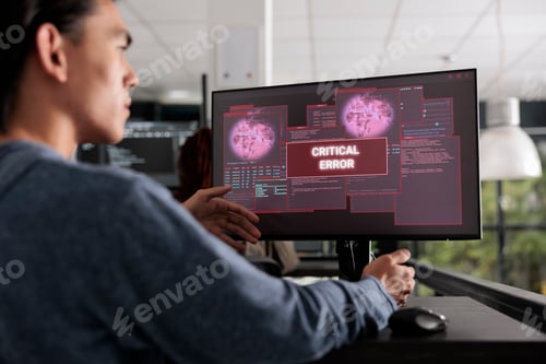 Preview: It programmer reading system error message on computer monitor
