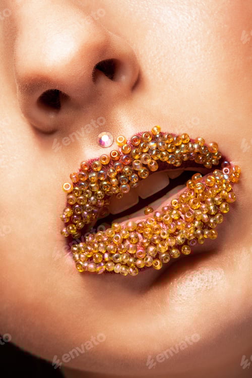Preview: Beautiful closeup with female plump lips and acrylic beads