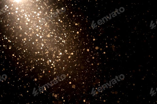 Preview: Organic dust particles floating in light ray on black background. Glittering sparkling flickering