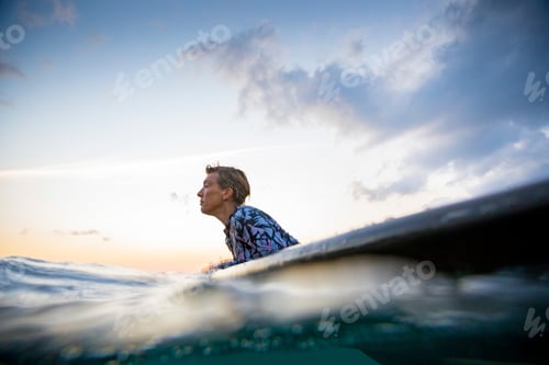 Preview: Surfer gliding in sea at sunset, Pagudpud, Ilocos Norte, Philippines