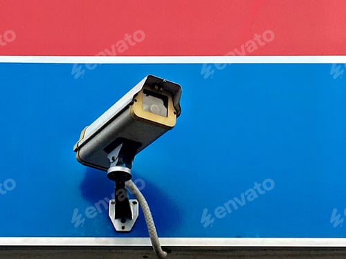 Preview: Low angle view of Security camera against blue wall