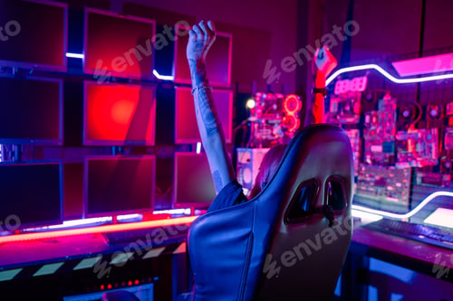 Preview: Happy Gamer young plays online video games computer she raises hands to wins tournament
