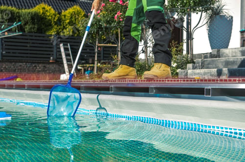 Preview: Poolside Maintenance Worker Cleaning Water Surface with a Net