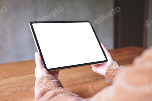 Preview: Hands Hold Blank Screen Tablet Device on Table