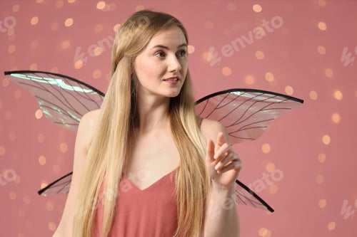 Preview: Beautiful girl in fairy costume with wings on pink background