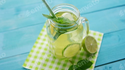Preview: Glass with lime cocktail and straw