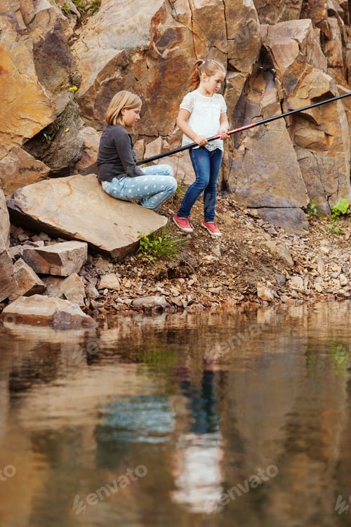 Preview: Sisters on rocks fishing in lake