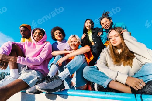 Preview: Multiracial group of young friends bonding outdoors