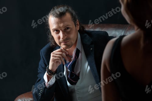 Preview: The Artist Or Mature Man Wearing Suit In A Classical Retro Fashion Style. The Woman Standing Near