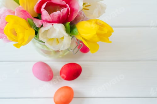 Preview: Fresh spring flowers with painted eggs for Easter celebration
