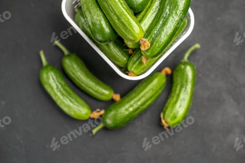 Preview: top view fresh green cucumbers inside basket on dark background food health photo salad meal color