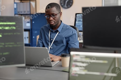 Preview: Software Developer Using Laptop in IT Company Office