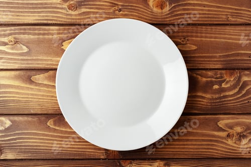 Preview: White ceramic plate on wooden background top view