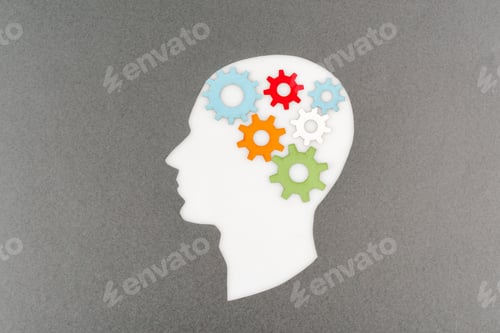 Preview: top view of cut out white human head with colorful gears isolated on grey
