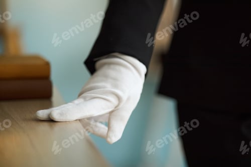 Preview: Close-Up of White Gloved Hand Checking Table for Dust