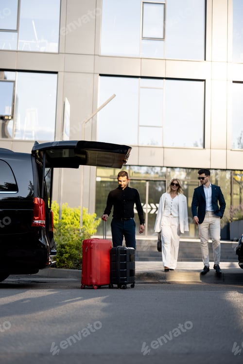 Preview: Driver helps a business couple carry their suitcases to the car from a hotel