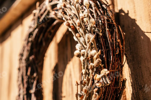 Preview: Tightly woven hanging willow wreath from wickers with decorative cotton twigs and white tape lace.