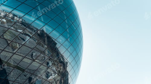 Preview: Large glass blue sphere against the sky, exterior. Modern futuristic architecture ball