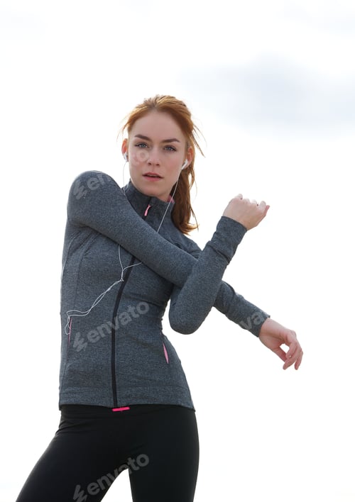 Preview: Sporty young woman stretching muscles