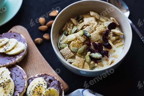 Preview: Healthy breakfast. Fresh granola, muesli with milk berries nuts. View from above.