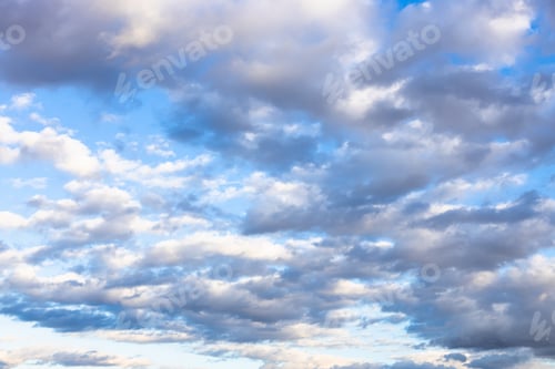 Preview: many gray and white low clouds in blue autumn sky