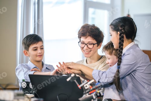 Preview: Happy children learn programming using laptops on extracurricular classes
