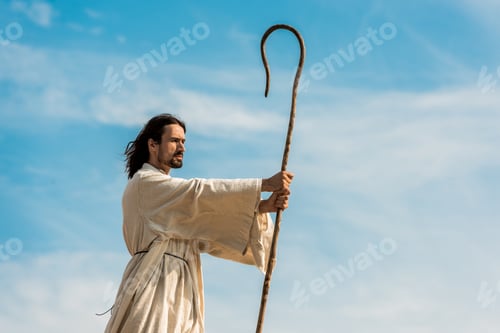 Preview: handsome bearded man holding wooden cane