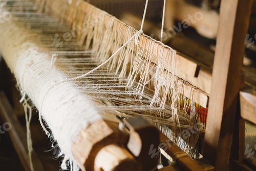 Preview: Old wooden hand loom. Ancient weaving loom in interior of wooden log hut
