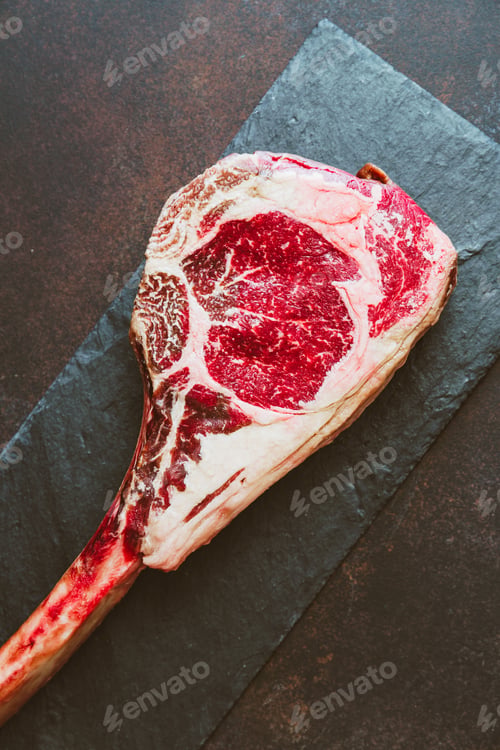 Preview: Top view of raw dry-aged marble beef steak Tomahawk