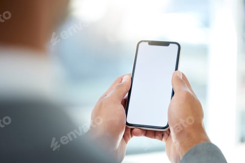 Preview: Cropped shot of an unrecognizable businessman using his cellphone while standing in the office
