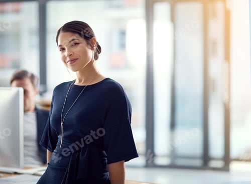 Preview: Cropped portrait of a young businesswoman with her colleague blurred in the background