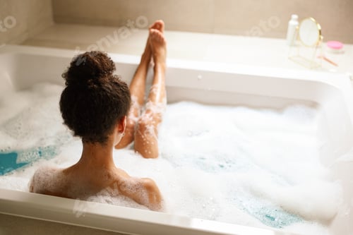 Preview: A young woman is happily bathing in a bathtub