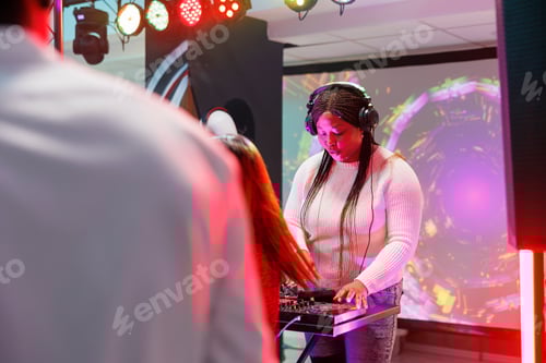 Preview: Woman dj mixing music in nightclub